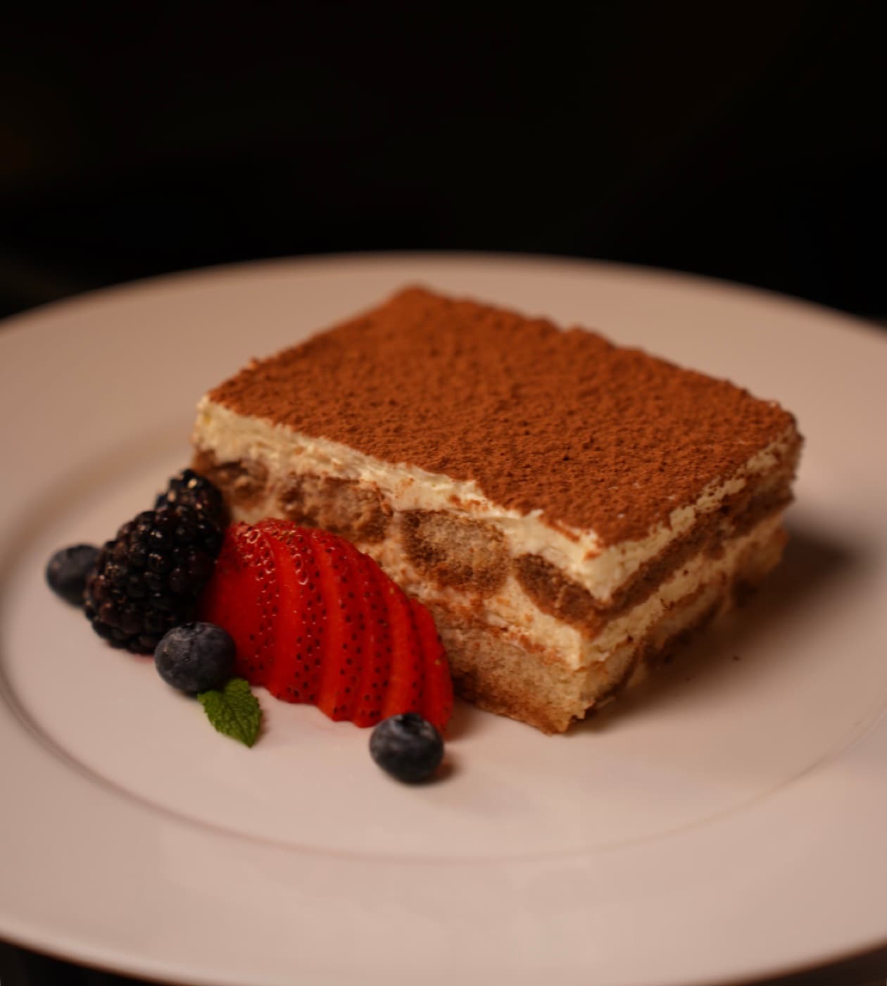 Tiramisu dusted with cocoa and fresh berries at Thanks to Harrison